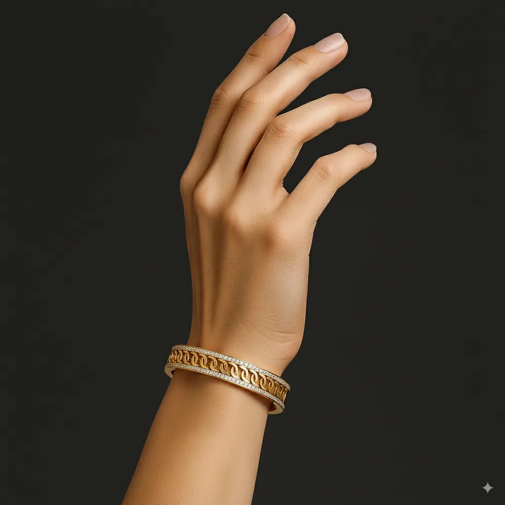 Hand wearing a gold bracelet on a black background