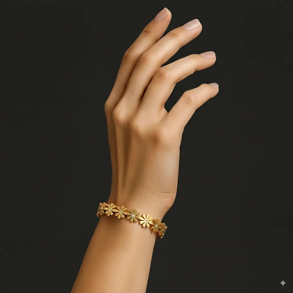 Gold bracelet on a hand against a black background